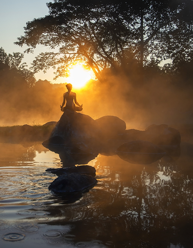 Silhouette of a Yoga woman in the morning at the hot spring park