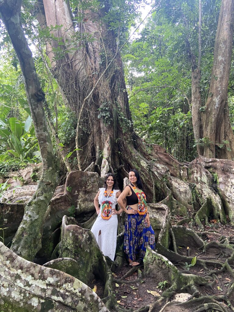 Maria Alix and a Friend standing in front of a large tree in the jungle